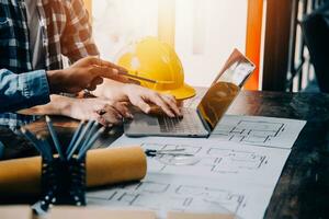 Construction and structure concept of engineer working drawing on blueprint meeting for project working with partner on model building and engineering tools in working site, construction concept. photo