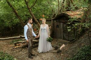 wedding walk of the bride and groom in a coniferous in elven accessories photo