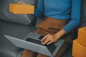 Business woman start up small business entrepreneur SME success .freelance woman working at home with Online Parcel delivery. SME and packaging deliveryconcept photo