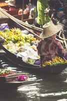 Traditional floating market in Damnoen Saduak near Bangkok photo