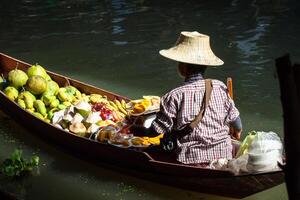 Traditional floating market in Damnoen Saduak near Bangkok photo