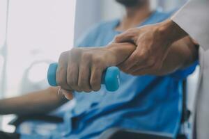 Physical therapist guiding patient with resistance band photo