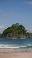 Boats on the backdrop of a tropical island in the ocean in Indonesia video