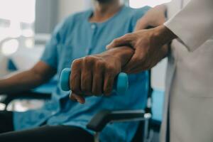 Doctor or Physiotherapist working examining treating injured arm of athlete male patient, stretching and exercise, Doing the Rehabilitation therapy pain in clinic. photo