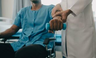 Doctor or Physiotherapist working examining treating injured arm of athlete male patient, stretching and exercise, Doing the Rehabilitation therapy pain in clinic. photo