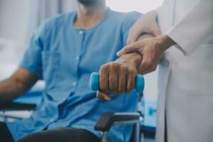 Physical therapist guiding patient with resistance band photo