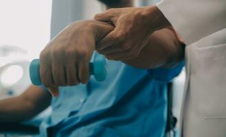 Doctor or Physiotherapist working examining treating injured arm of athlete male patient, stretching and exercise, Doing the Rehabilitation therapy pain in clinic. photo