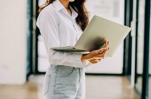 mujer de negocios asiática que usa calculadora y computadora portátil para hacer finanzas matemáticas en un escritorio de oficina, impuestos, informes, contabilidad, estadísticas y concepto de investigación analítica foto