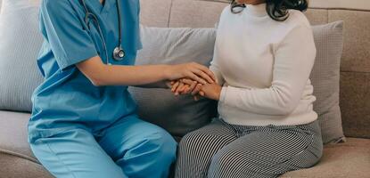 Asian doctor woman visited patient woman to diagnosis and check up health at home or private hospital. Female patient explain health problem and symptoms to doctor .Health care premium service at home photo