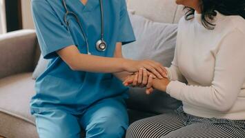 Asian doctor woman visited patient woman to diagnosis and check up health at home or private hospital. Female patient explain health problem and symptoms to doctor .Health care premium service at home photo