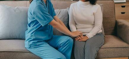 Asian doctor woman visited patient woman to diagnosis and check up health at home or private hospital. Female patient explain health problem and symptoms to doctor .Health care premium service at home photo