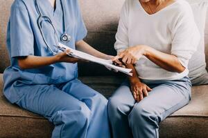 Doctor showing medical card to patient at table in clinic, closeup photo