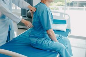 Patient doing some special exercises under supervision in a room photo