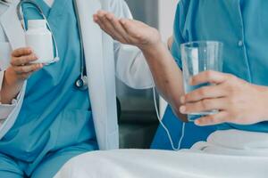 Injured patient showing doctor broken wrist and arm with bandage in hospital office or emergency room. Sprain, stress fracture or repetitive strain injury in hand. Nurse helping customer. First aid. photo