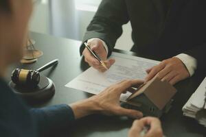 Lawyer, legal advisor, businessman brainstorming information on agreement details Business contracts in legal processing books for accuracy in contract documents. joint financial investment. photo