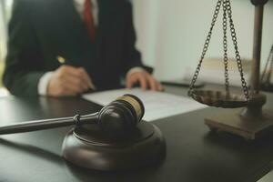 Lawyer, legal advisor, businessman brainstorming information on agreement details Business contracts in legal processing books for accuracy in contract documents. joint financial investment. photo