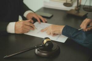 Lawyer, legal advisor, businessman brainstorming information on agreement details Business contracts in legal processing books for accuracy in contract documents. joint financial investment. photo