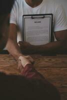 Close up view of job interview in office, focus on resume writing tips, employer reviewing good cv of prepared skilled applicant, recruiter considering application, hr manager making hiring decision photo