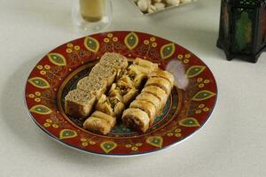 Mini Peanut Baklava on Red Ceramic Plate photo