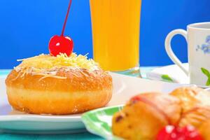 rosquillas decorado con cerezas y rociado con queso y en polvo azúcar foto