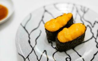 Uni Sushi,  traditional food in Japanese Restaurant. Uni sea urchin sushi japanese cuisine in ceramic plate. photo