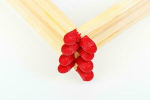 matches with a red head on a white background photo