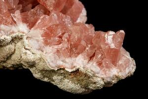 Macro mineral stone Pink Amethyst on a black background photo