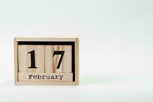 Wooden calendar February 17 on a white background photo