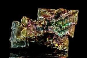 Macro of the stone bismuth mineral on a black background photo