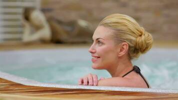 Beautiful woman relaxing in a hot tub. video