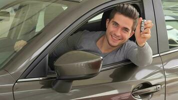 Man showing the key of his new car video