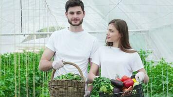 Farmers with a basket full harvest smiling directly at the camera video