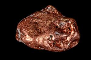Macro mineral stone of a copper nugget on a microcline on a black background photo