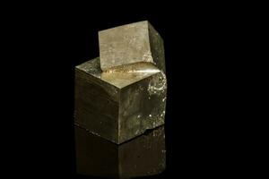 Macro mineral stone Pyrite on a black background photo