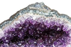 Macro Mineral Stone Amethysts in the rock on a white background photo