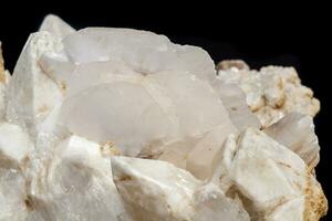 Macro mineral stone Snow quartz with calcite on a black background photo