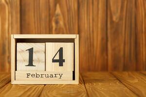 white pieces of paper on clothespins with a heart on a wooden background, calendar February 14 photo