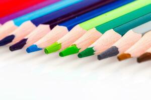 macro multicolored pencils on a white background photo