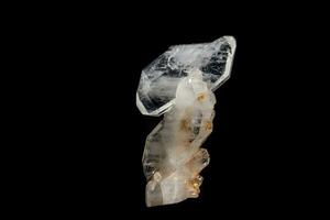 Macro mineral stone Flattened crystal of rock crystal on a black background photo