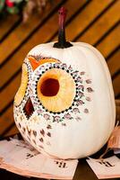 pumpkin in the form of an owl, an owl carved from a pumpkin, into a halloween photo