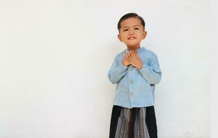 A cute relax little boy feel comfort and peace with blue shirt and sarong photo