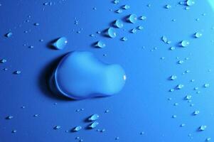 a blue apple on a blue background with water droplets photo