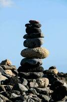 a stack of rocks on a rocky beach photo