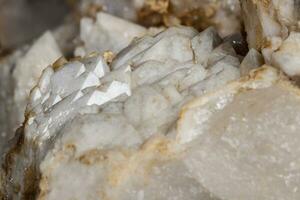 Macro mineral stone Snow quartz with calcite on a black background photo