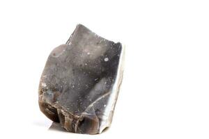 Macro mineral stone Flint in the rock on a white background photo