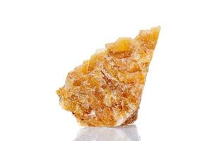 macro mineral stone yellow calcite on a white background photo