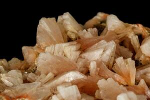 Macro of a stone Stilbite mineral on a black background photo