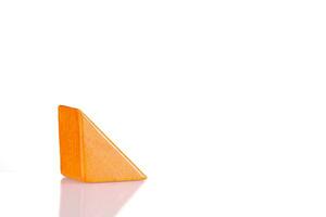 Wooden triangle orange colors on a white background photo