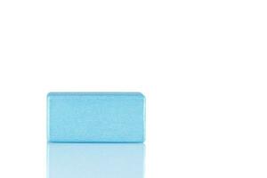 Wooden cube of blue color on a white background photo