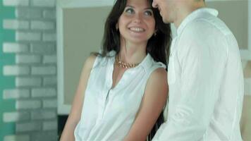 Couple looking eye to eye with tenderness while cooking dinner video